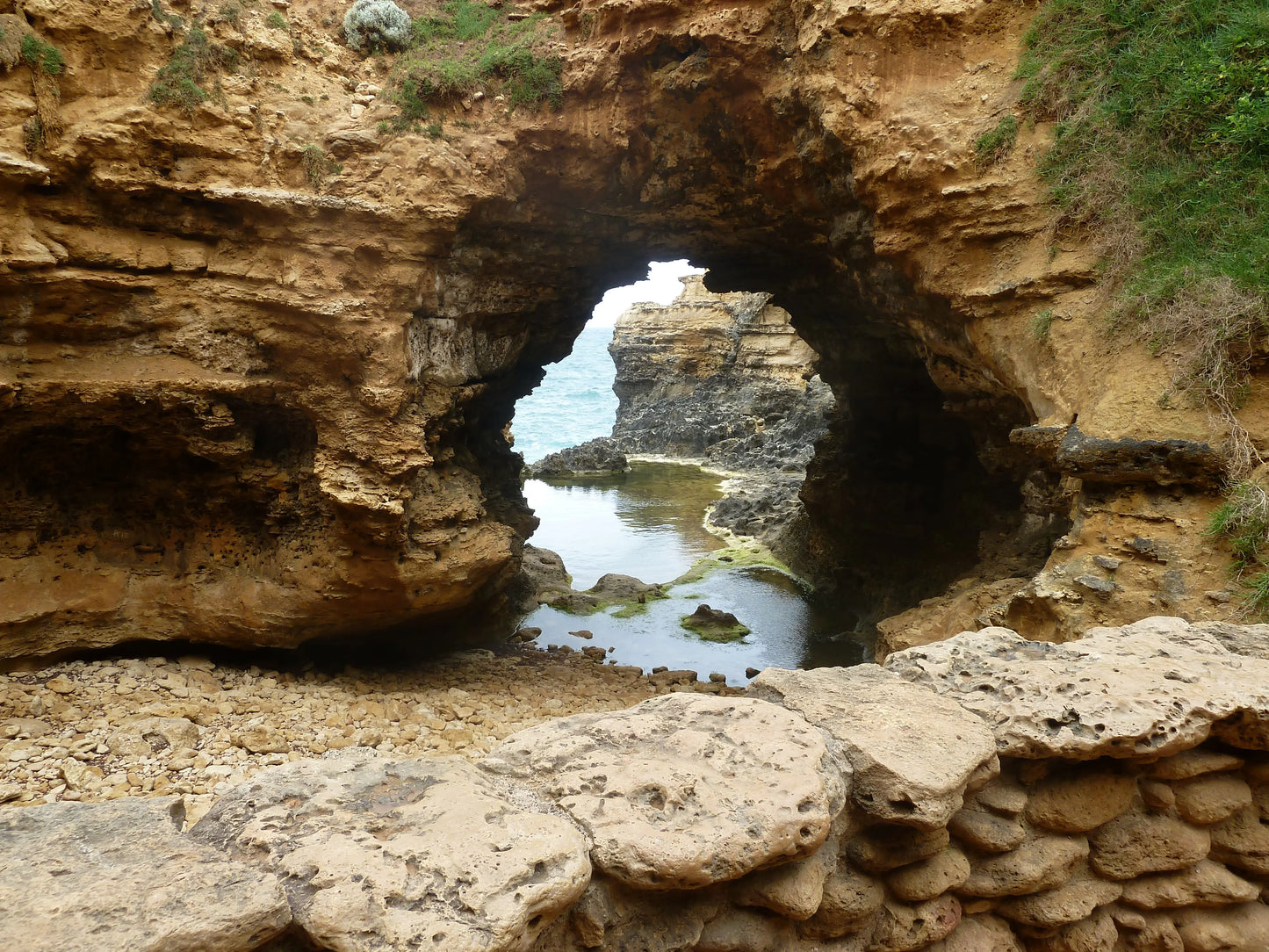 Natural limestone arch and rock pool at The Grotto, Port Campbell National Park, Australia.